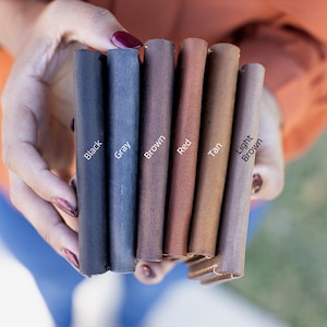 May include: Leather swatches in black, gray, brown, red, tan, and light brown.