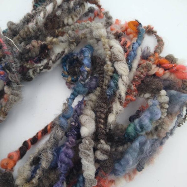 Matilda Art Yarn...  browns, coral orange, and blue/purple 11 yards