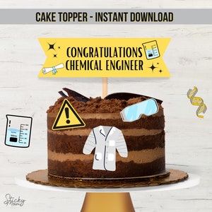 May include: A chocolate cake with a yellow banner that says "Congratulations Chemical Engineer". The cake is decorated with a lab coat, goggles, a beaker, a DNA strand, and a warning sign.