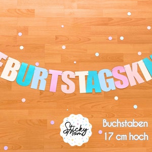 May include: A pastel coloured banner with the German words "Geburtstagskind" which translates to "Birthday Child". The banner is made of paper and is strung together with white string. The letters are 17 cm high.