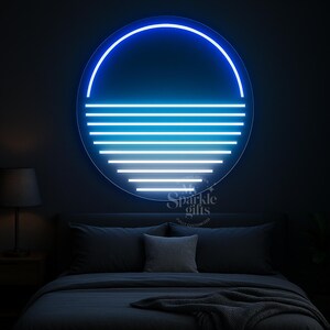 May include: A circular neon wall light featuring a glowing blue outline and a series of horizontal white lines that decrease in length toward the bottom. The design resembles a sunset over water. The text My Sparkle Gifts is visible.