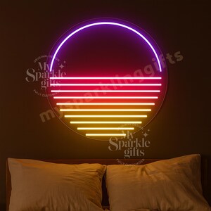 May include: A circular neon wall sign featuring a gradient sunset design. The top arc is purple, transitioning into horizontal lines of pink, red, orange, and yellow. The text My Sparkle Gifts is visible in a watermark overlay on the sign.