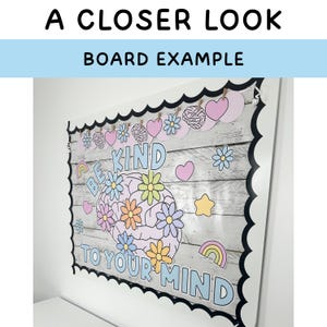 May include: A white noticeboard with a black scalloped border. The board has a woodgrain pattern and is decorated with colourful cutouts, including a brain, flowers, hearts, stars, and rainbows. The text "Be Kind to Your Mind" is written in blue and black letters.