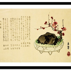 May include: A traditional Japanese painting of a bonsai tree with pink blossoms in a white pot. The tree is growing out of a rock and is surrounded by green moss. The painting is on a light brown background with Japanese text.