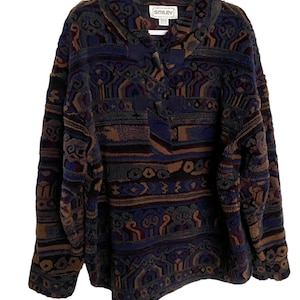 May include: A blue, brown, and green patterned fleece pullover with a button closure at the neck. The label reads "SMILEY".