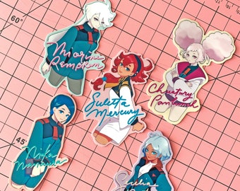 May include: Five colorful stickers featuring anime characters with their names written in cursive. The characters are dressed in blue and white outfits with accents of red, yellow, and pink. The stickers are on a pink and white grid background.