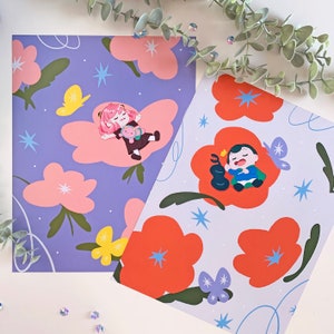 May include: Two illustrated prints featuring a purple background with white stars and pink flowers. One print features a girl with pink hair and a white dress sleeping on a cloud. The other print features a boy with brown hair and a blue shirt sleeping on a red flower.