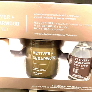 May include: A gift set containing a scented candle, room spray, and reed diffuser. The candle is 5 oz (142 g), the room spray is 2 fl oz (60 ml), and the diffuser is 1 fl oz (30 ml). The products are labeled "Vetiver + Cedarwood".