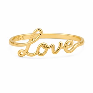 Puede incluir: Un anillo dorado con la palabra "Love" en escritura cursiva. El anillo está hecho de un metal brillante y tiene el número "925" estampado en la banda. El anillo es un diseño simple y elegante.