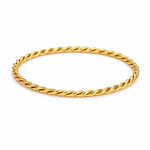 May include: A thin, circular bangle bracelet crafted from polished yellow gold. The metal surface features a continuous, uniform twisted rope texture that creates a repeating spiral pattern around the entire circumference of the jewelry piece.
