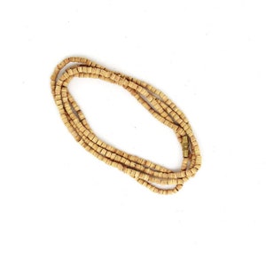 May include: A long strand of light brown wooden beads with a gold metal clasp.
