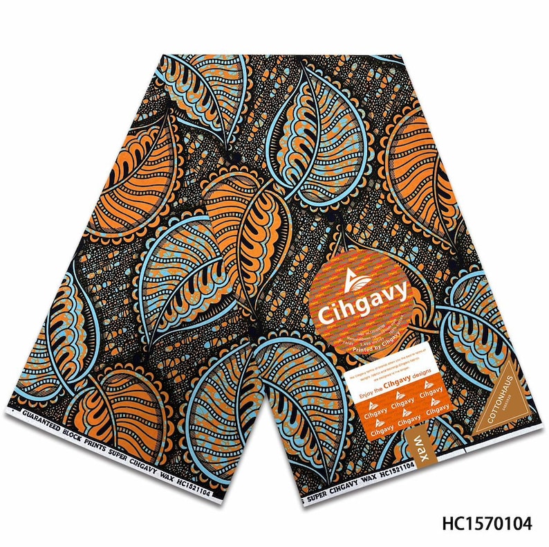 May include: A piece of fabric featuring a repeating pattern of large orange and light blue leaves on a dark brown background. The textile includes a circular logo with the text Cihgavy and a rectangular label with the text Cottonhaus wax.