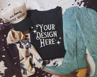 May include: A selection of Western-style items: a black t-shirt with "YOUR DESIGN HERE" text, a cream baseball cap with "say howdy STAY ROWDY" text, a patterned scarf, and turquoise cowboy boots.