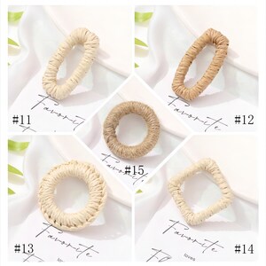 May include: A collection of five woven raffia rings in various shapes: oval, rectangle, and circle. The rings are in shades of beige and tan. The word "Favorite" is written on the background.