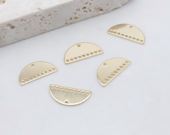 May include: Five gold half-circle metal charms with a decorative border of small circles. The charms have a hole at the top for attaching to jewelry or other crafts.