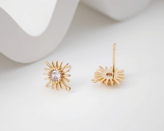 May include: Gold-tone earring findings with a starburst design and a clear rhinestone in the center. The findings have a loop on the bottom for attaching a dangle charm.