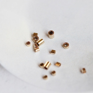 50 stuks: goudgevulde knijpkralen, positiekralen 1,6 x 1 mm/1,1 x 1 mm, 14 kt gouden knijpkralen, gouden knijpkralen, B012