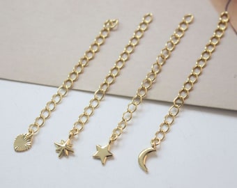 May include: Four gold chain extenders with different charms: a star, a crescent moon, a starburst, and a sunburst.