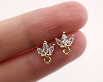 May include: Two gold-toned jewelry findings with a crown-shaped design featuring clear marquise-shaped stones. Each finding has a small loop for attaching to jewelry.