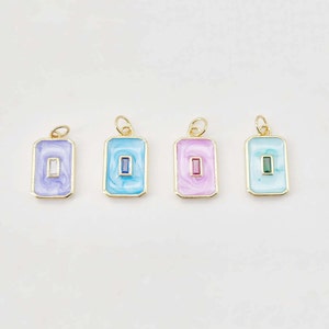 May include: Four gold-toned rectangular pendants with different colored enamel and a single gemstone in the center. The pendants are on a white background.