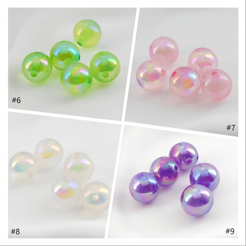 May include: Assortment of iridescent glass beads in various colors, including green, pink, white, and purple. The beads are round and have a smooth, glossy finish.