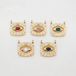 May include: Five gold-tone pendants with an evil eye design. Each pendant features a different colored gemstone in the center of the eye: red, pink, green, clear, and black.