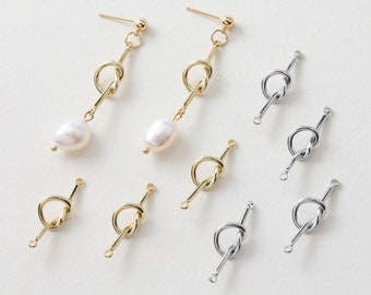 May include: A set of gold and silver knot-shaped earring connectors. The connectors are made of metal and have a smooth finish. They are perfect for adding a touch of elegance to your jewelry designs.