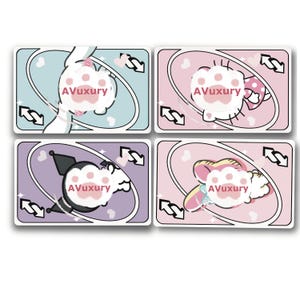 May include: Four playing cards with cartoon character designs. Each card features a different character on a pastel background, with the text "AVuxury". The cards have a reverse arrow symbol and heart shapes.