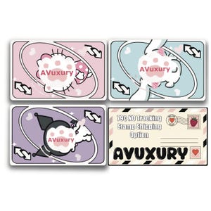 May include: Four decorative cards with cartoon animal designs. The cards feature a white cat, a white bunny, and a black and white character. The fourth card has text that reads "AVUXURY". The cards are in pink, blue, and purple.