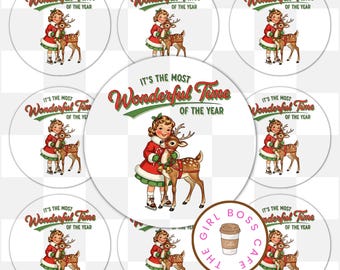 May include: A collection of round stickers featuring a vintage illustration of a girl in a red and white dress with a deer. The text "IT'S THE MOST Wonderful Time OF THE YEAR" is displayed in red and green. The Girl Boss Cafe logo is also visible.