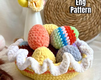May include: A handmade crochet basket filled with colorful, textured Easter eggs. The basket is yellow with a white, wavy trim. The eggs are various colors, including orange, yellow, blue, and green. Text on the image reads "Eng Pattern".