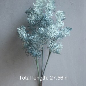 May include: A blue artificial plant sprig with feathery leaves. The sprig is 27.56 inches long.