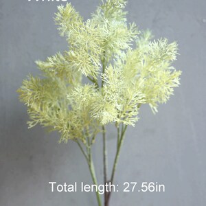 May include: White artificial greenery sprig with a feathery texture. The sprig is 27.56 inches long.