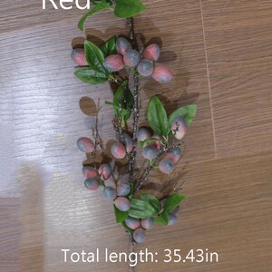 May include: A red berry sprig with green leaves and a total length of 35.43 inches. The berries are a dark blue with a red hue.