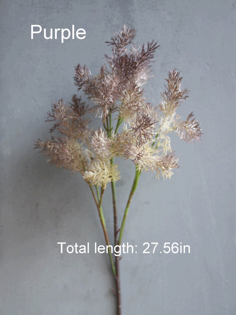 May include: Purple artificial flower sprig with a feathery texture. The stem is brown and the flower is a mix of light brown and purple. The total length is 27.56 inches.