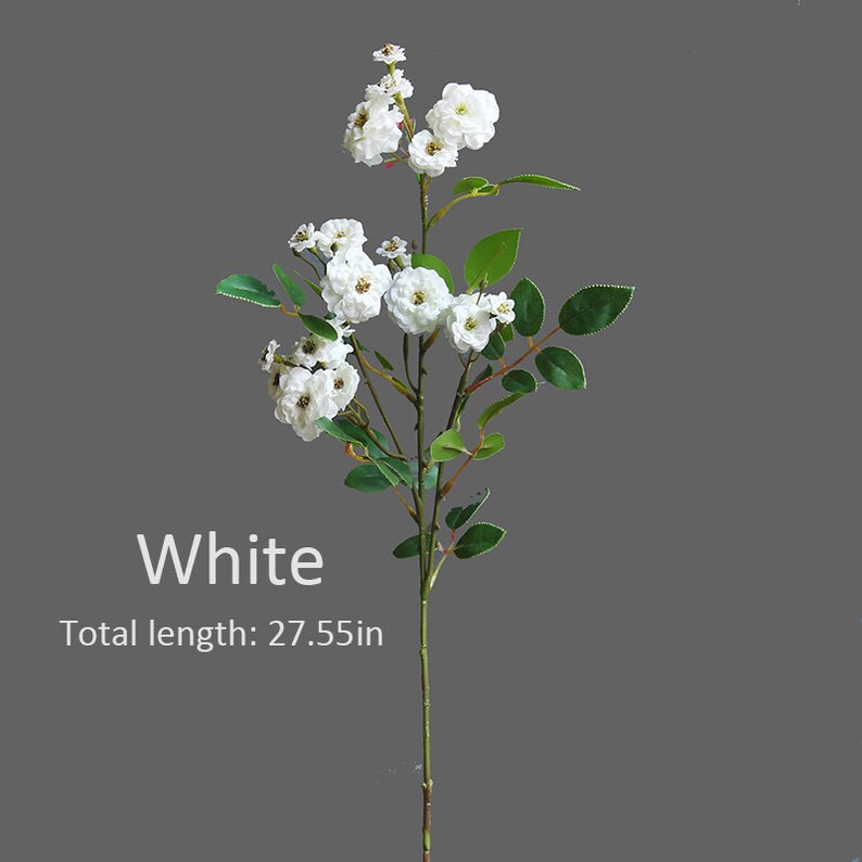 May include: White artificial flower stem with small white blossoms and green leaves. Total length: 27.55 in.