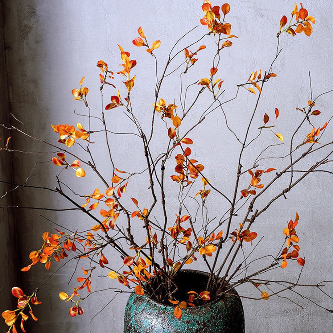 Diy potted planter with birch branches and fall leaf garlands