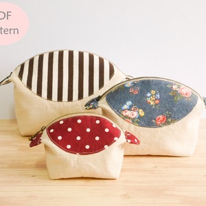 May include: Three different sized beige zippered pouches with fabric tops. The largest pouch has a brown and white striped fabric top, the middle pouch has a blue floral fabric top, and the smallest pouch has a red polka dot fabric top.  PDF Pattern.