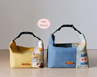 May include: Two fabric pouches with black adjustable buckle handles. The left pouch is yellow with a patterned side panel. The right pouch is blue with a patterned side panel featuring milk carton graphics. Both have small brown labels and text PDF Pattern.