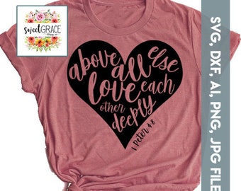 May include: A pink t-shirt with a black heart design. The heart has the text "above all else love each other deeply" and "1 Peter 4:8" inside.