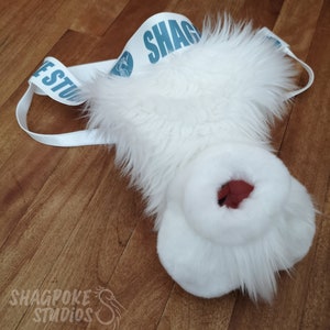 May include: White furry muzzle with a red nose and a white strap with the text "SHAG" in blue.