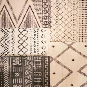 May include: A collection of five different patterned rugs with black and white geometric designs. The rugs are made of a soft, plush material and have a variety of textures.