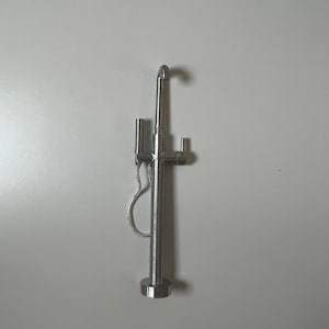 May include: A silver shower head with a handheld sprayer and a hose attached to the base.