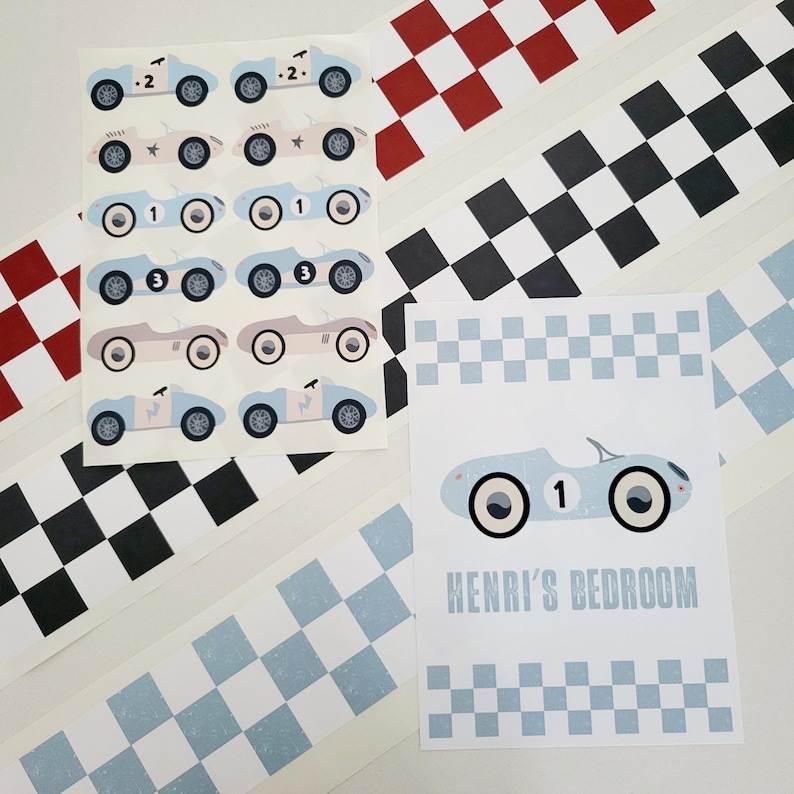 May include: A set of blue and white race car stickers with black and white checkered race track borders. The stickers feature different numbers and a star design. The set also includes a sign with a blue and white race car and the text "HENRI'S BEDROOM".