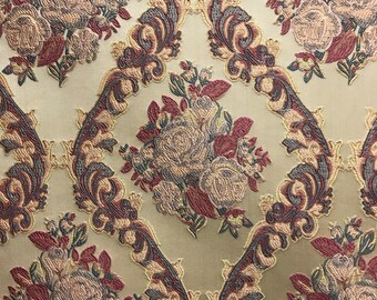 May include: Beige fabric with a repeating pattern of brown and gray floral designs. The fabric has a textured, woven look.