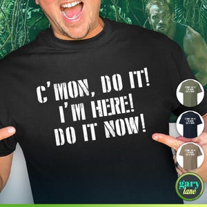 May include: Black t-shirt with white text that reads "C'mon, Do It! I'm Here! Do It Now!"