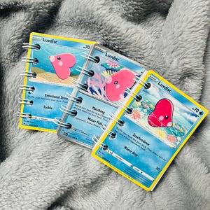 Caderno/bolso de cartas Pokémon Luvdisc. Presente ideal para o Dia dos Namorados!