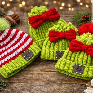 May include: A collection of handmade Christmas hats in various styles. One hat is red and white striped with a green pom-pom. Other hats are green with red bows. All hats have a small square patch.