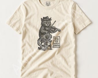 May include: Cream-colored t-shirt featuring a black and white illustration of a cat playing a violin while seated on a stool. The cat wears a hat and the text "WILL PLAY FOR WORLD DOMINATION" is below the cat.