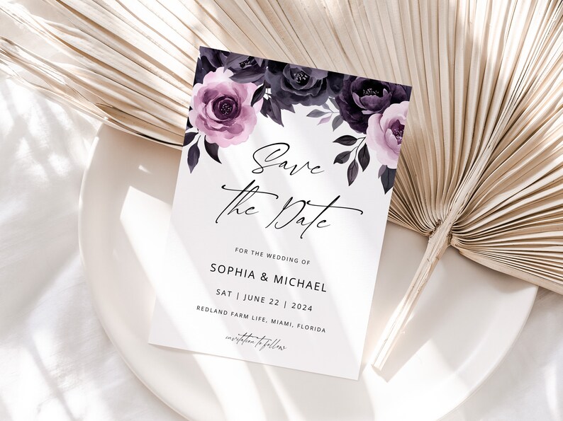 May include: Save the date card with a floral design featuring purple and black flowers. The text reads "Save the Date" for the wedding of Sophia & Michael on Saturday, June 22, 2024 at Redland Farm Life, Miami, Florida.